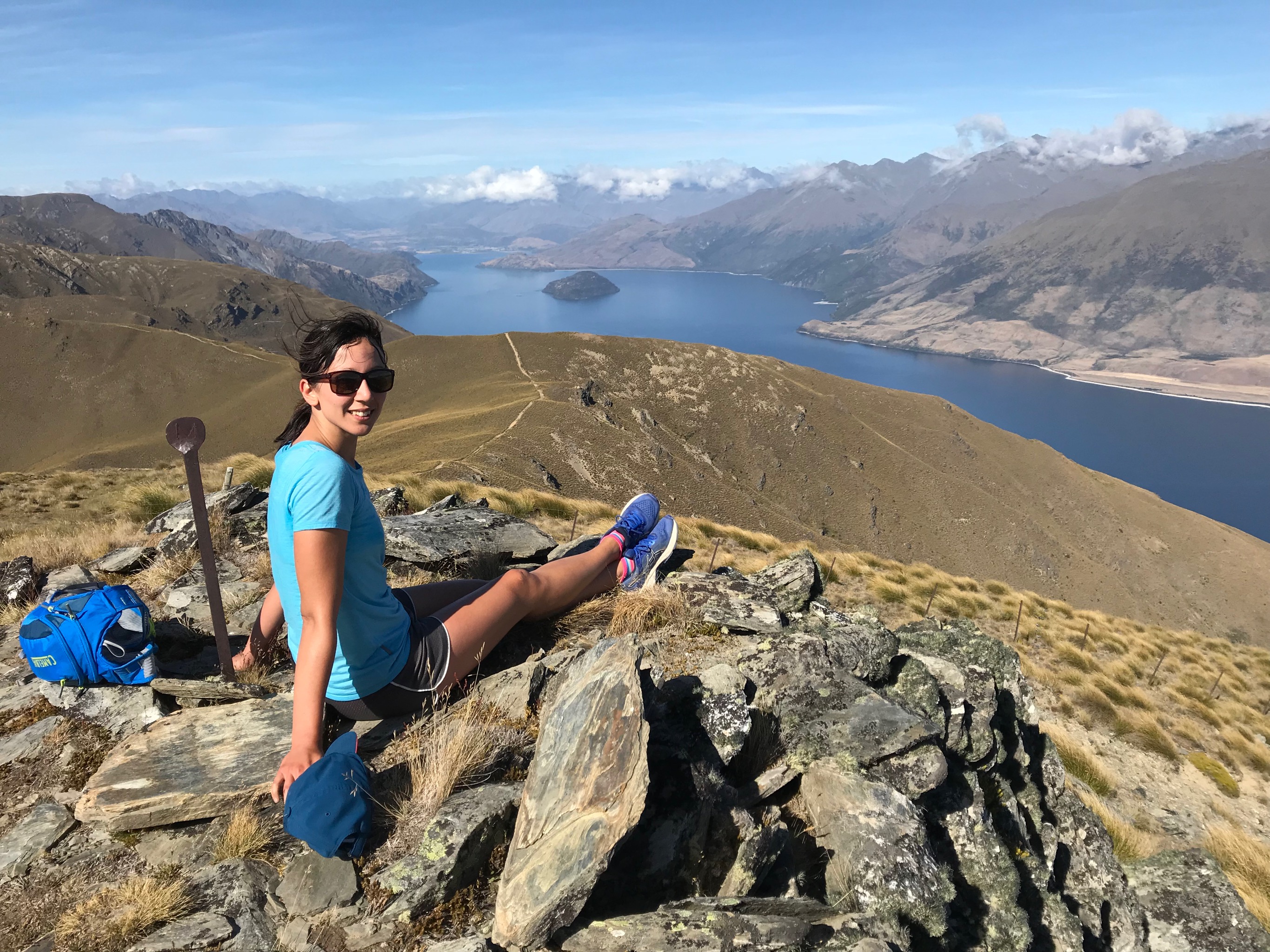 Alex relaxing at the next peak south along the ridgeline from Isthmus Peak, with Lake Wanaka in the background.