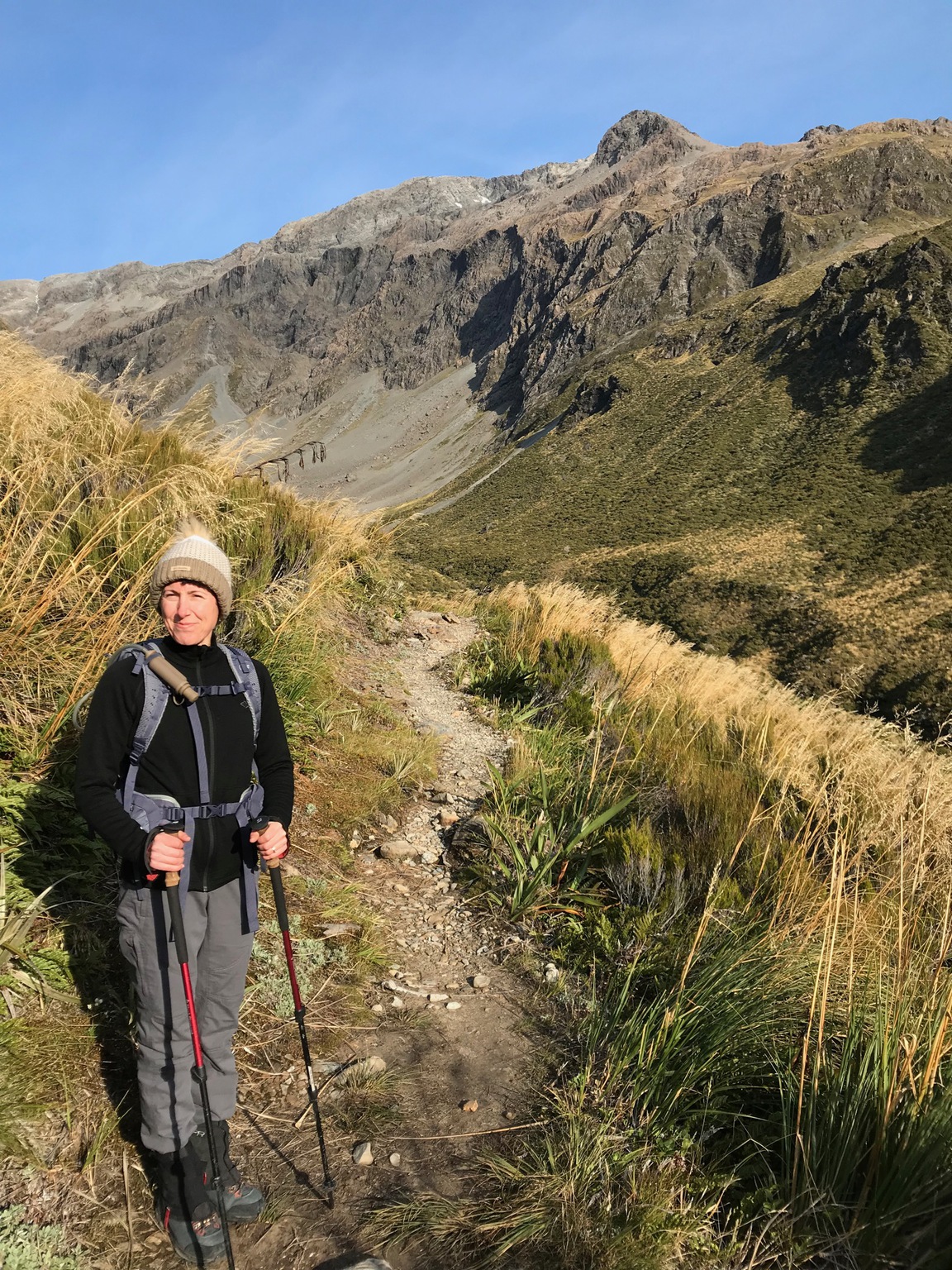Delphine poses near the start of hike up the Otira valley. The peak on the ridge is a false peak, with Mt Philistine further behind and not visible from the start of the climb.
